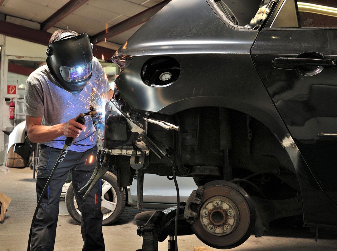Bodywork technician repairing a car panel